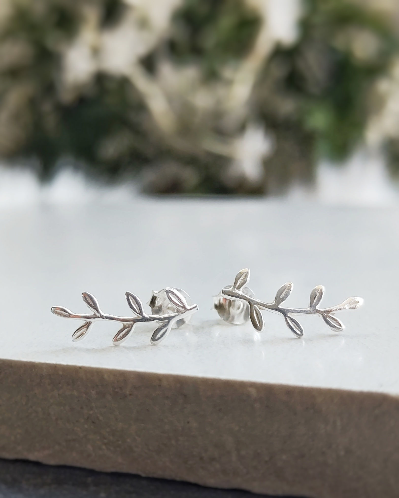 a pair of sterling silver vine leaf stud earrings