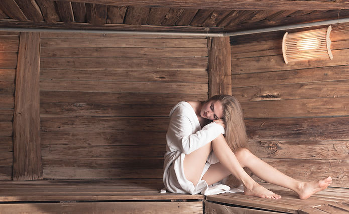 woman-bathrobe-sitting-wooden-bench-relaxing-sauna (1).jpg