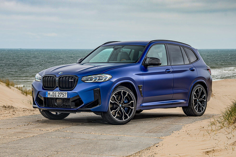 Blue BMW X3 M SUV parked on the beach, ocean background in view. Autos Estrella