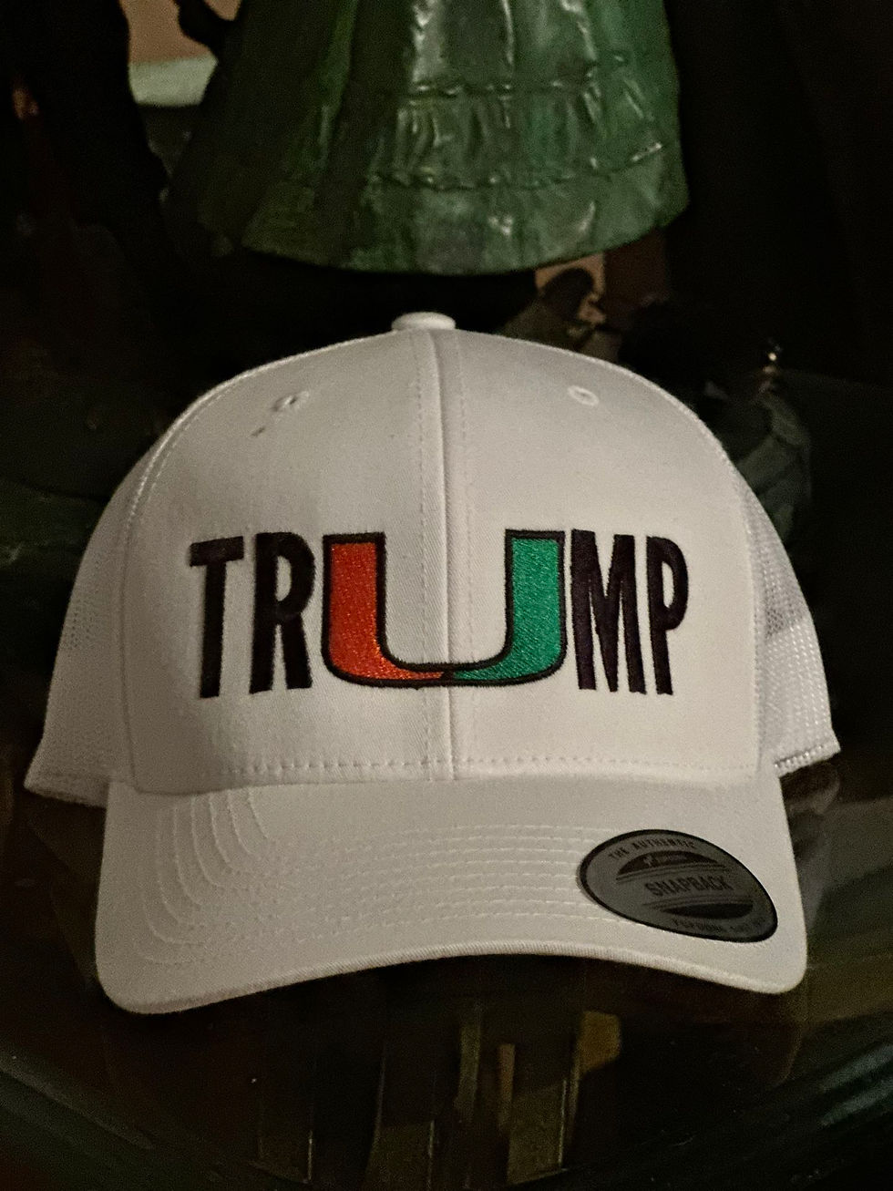 Some students have gone the extra mile to market UM-inspired Trump hats, promoting designs which creatively substitute the 'u' in his surname for the UM logo. (Photo Credit: OfferUp)