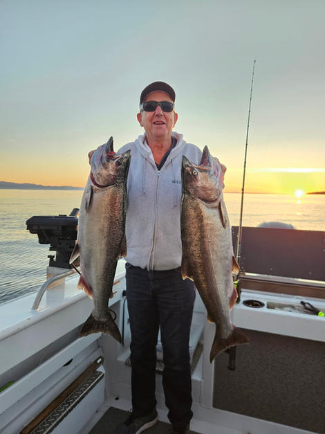 Happy client holding salmon on Sooke Fishing Charter in Sooke BC
