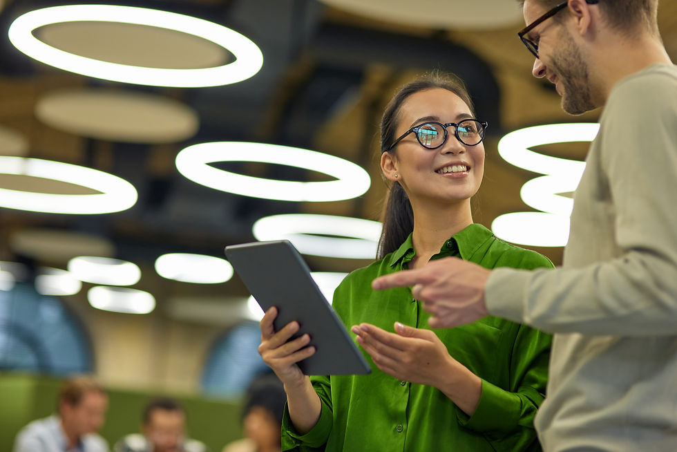young positive asian woman showing something digital tablet her male