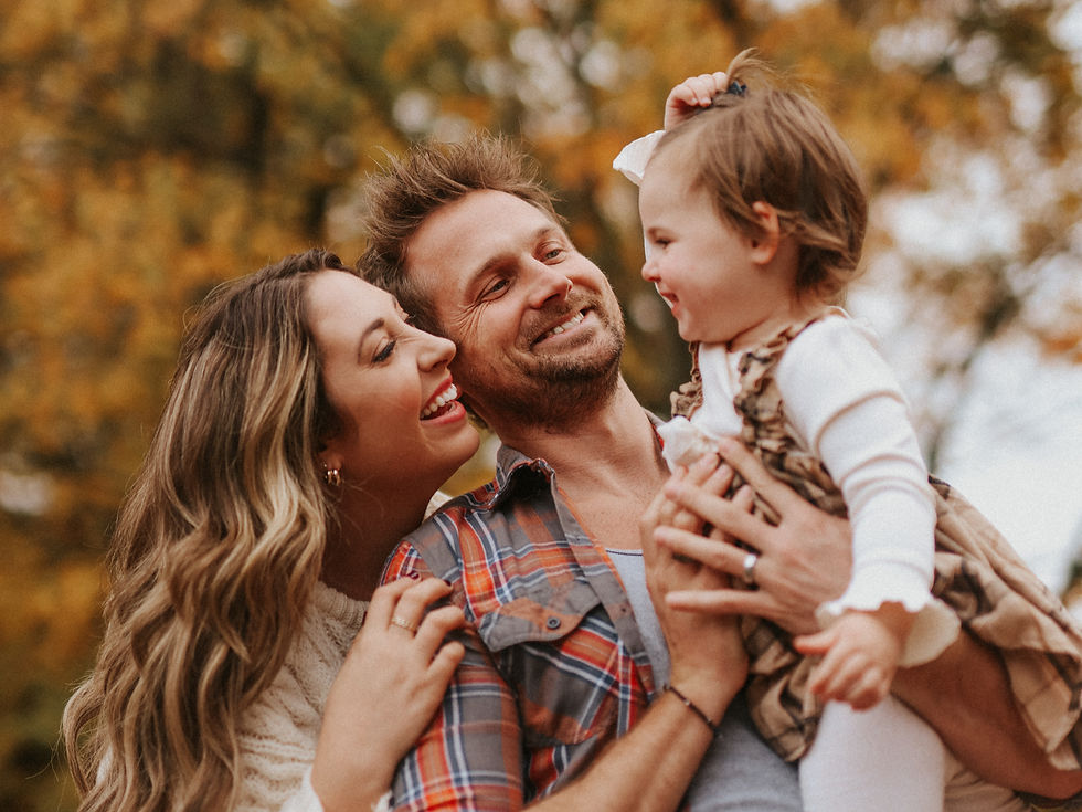 close up photo of couple looking at their kid