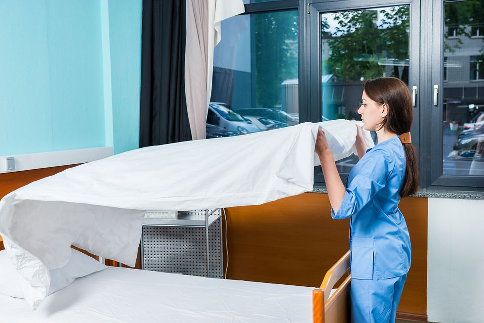 young female nurse blue uniform changing bedsheets hospital bed hospital ward healthcare concept