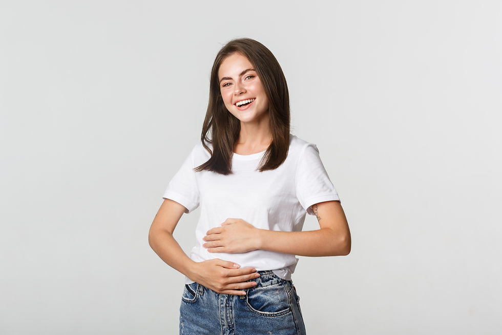 satisfied smiling brunette girl rubbing belly after eating delicious food
