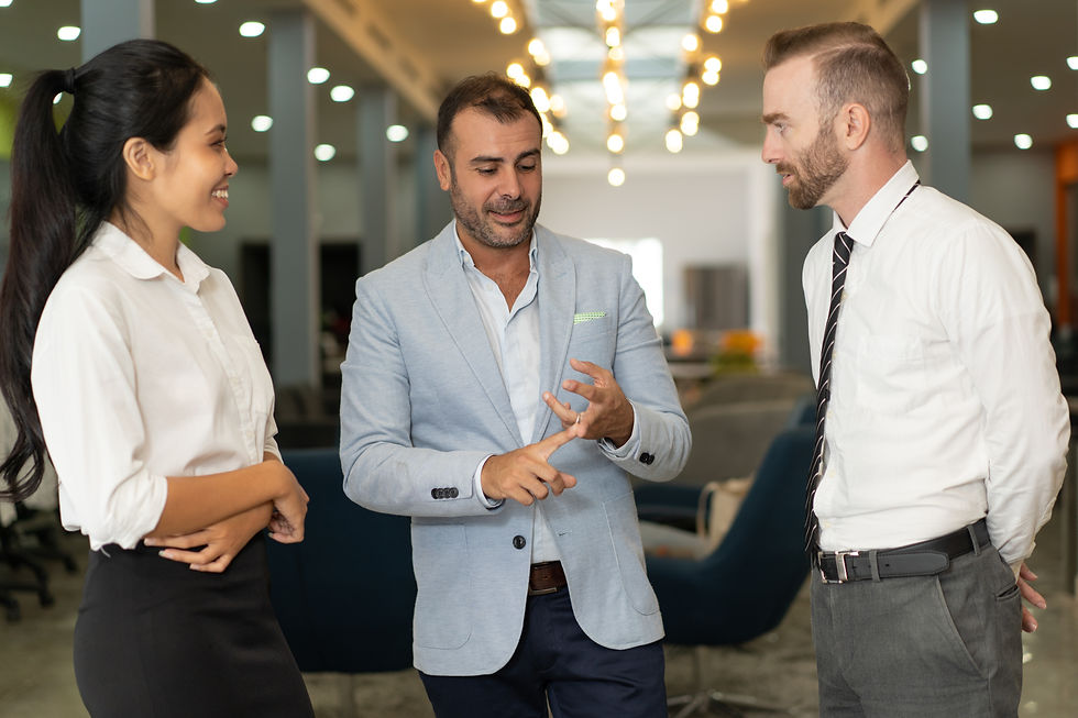 three positive business people talking office lobby.
