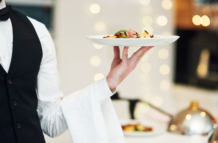 Server holding a tray of passed hors d'oeuvres