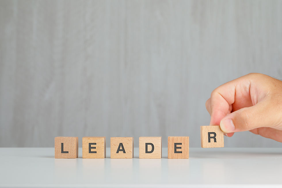 leadership concept grey white table side view hand picking up wooden cube