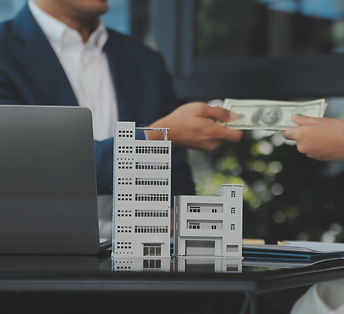 hands exchanging money for real estate transaction