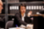investigator answering landline phone call in archive room