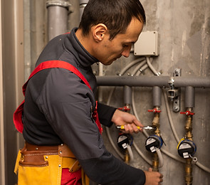 building-profession-people-concept-builder-plumber-working-with-water-pipes-boiler-room.jp