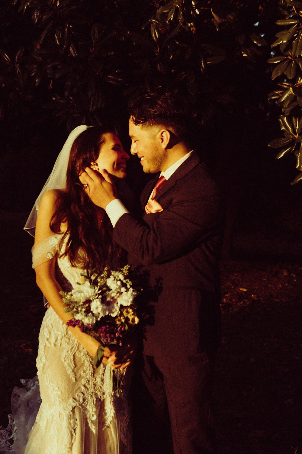 Smiling bride and groom embrace at their Analea wedding