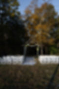 Outdoor ceremony setup by Analea Wedding Co. with wooden arch.