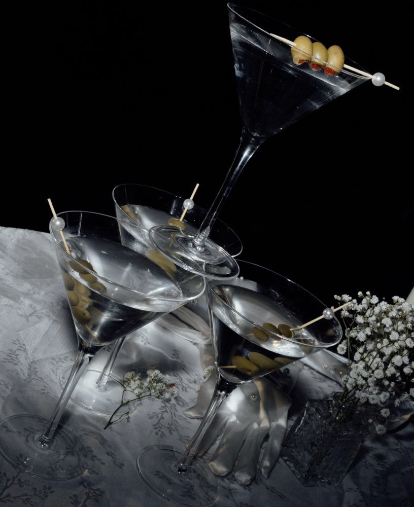 Martini glasses with olives for place card design context