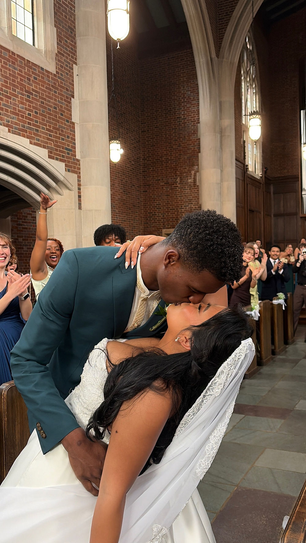Groom dips and kisses bride at their wedding