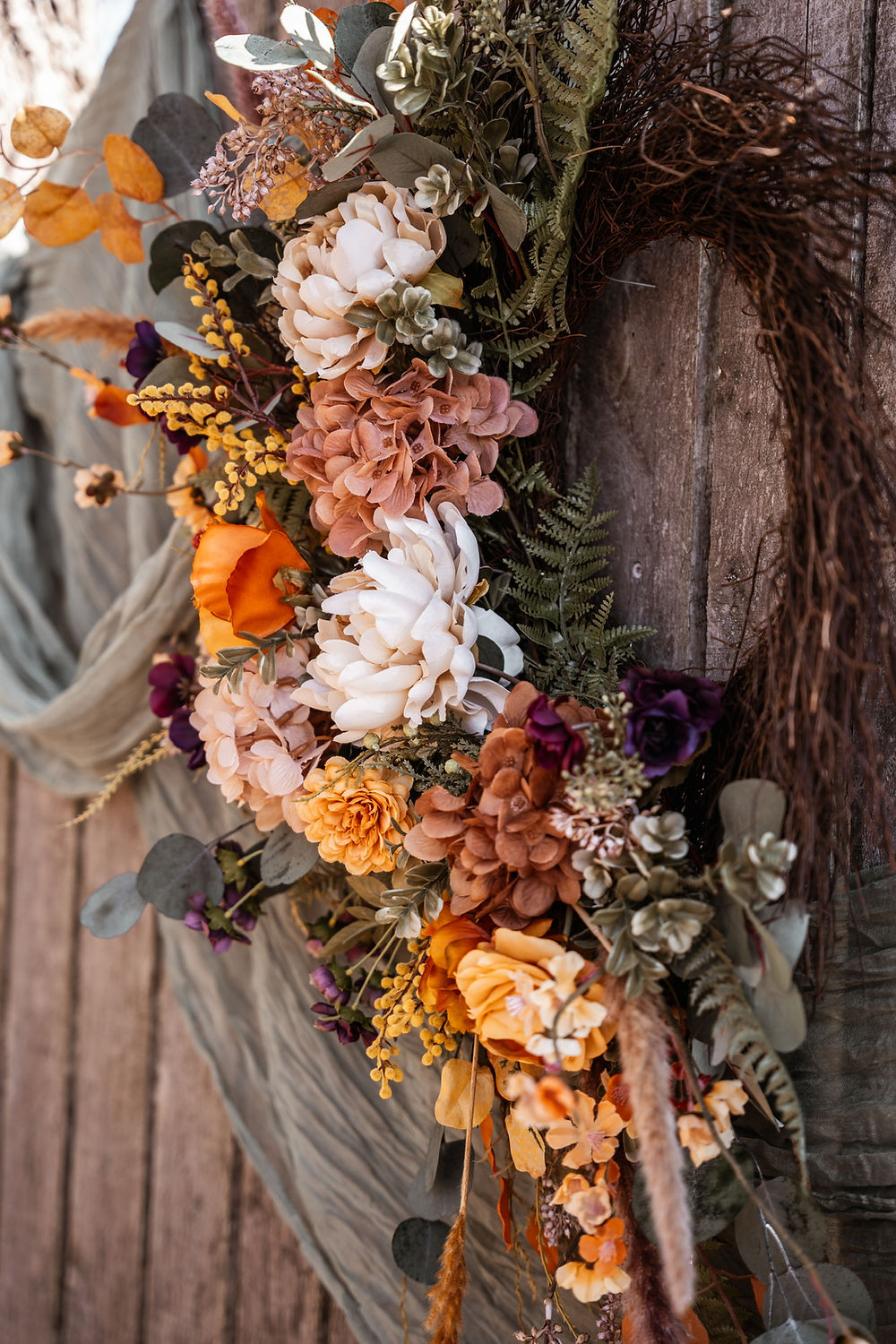 Rustic fall floral wreath with peach and orange flowers