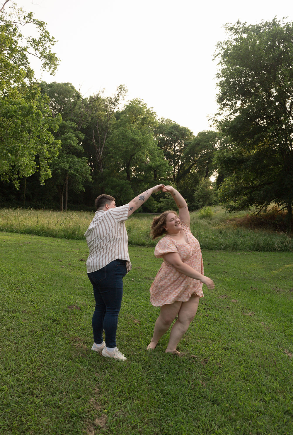 Joyful couple dancing outdoors in a field