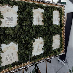 Moss-covered seating chart for large quantity event setup