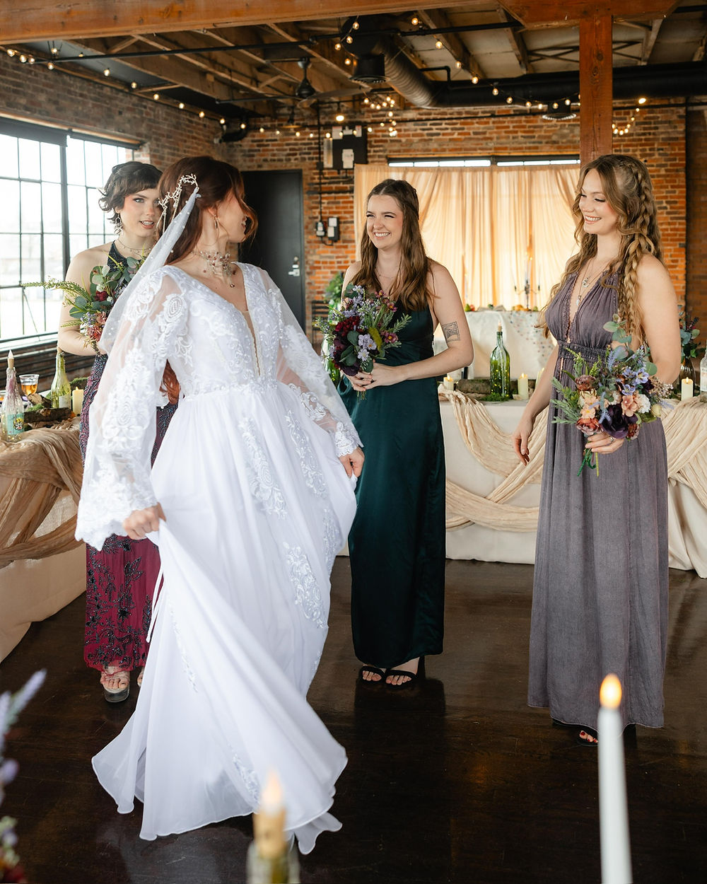 Bride and bridesmaids smile at an analea wedding co. reception.