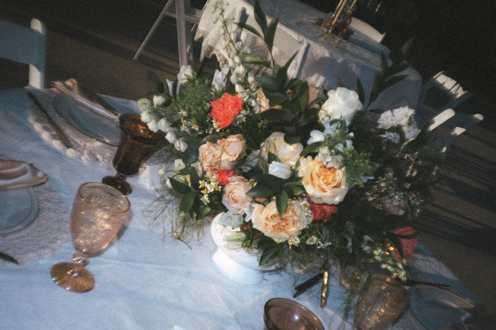 Floral centerpiece on a set table for a vendor meeting.