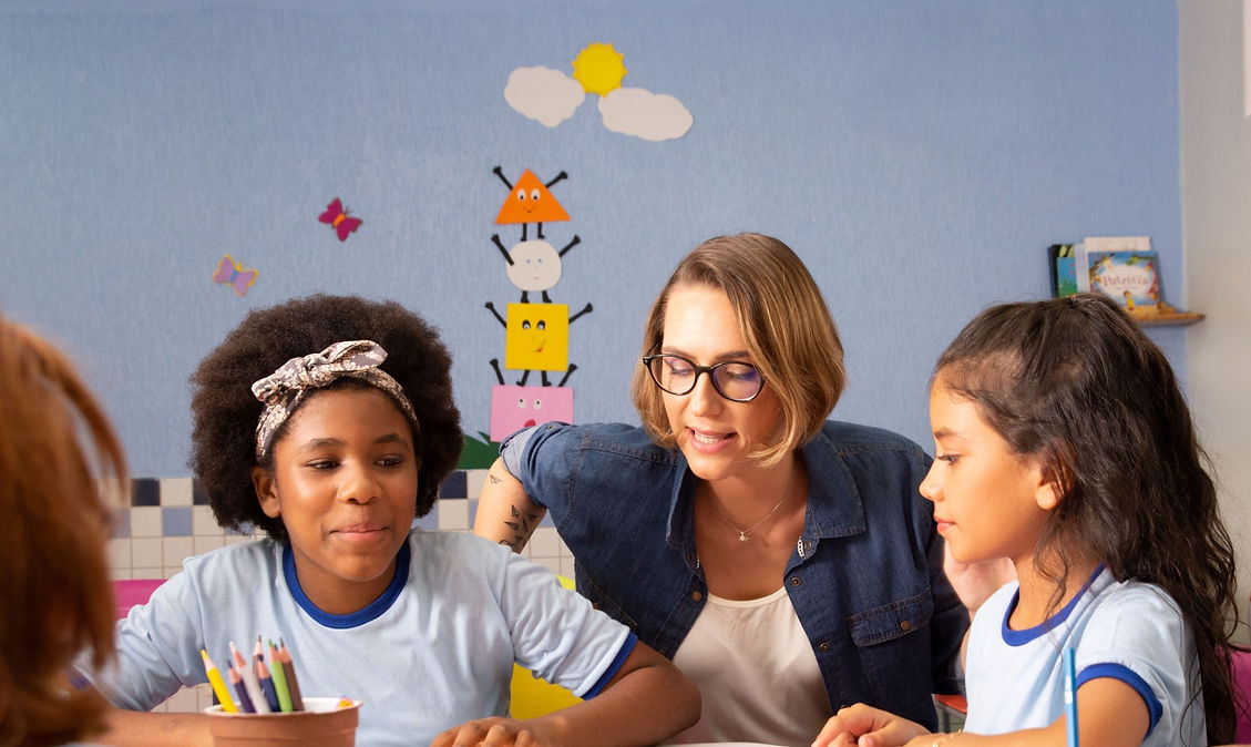 The image shows a teacher with a student in the class