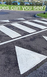 The picture shows a road with sign shapes