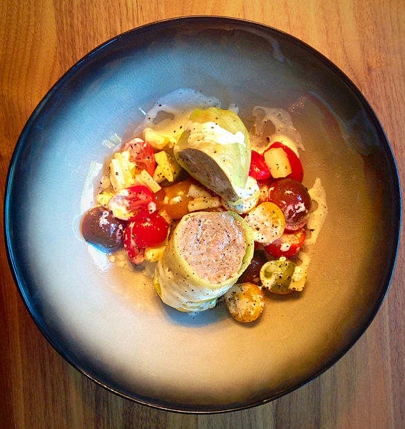 Stuffed cabbage leaves with cherry tomato salad