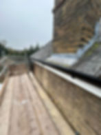 Close-up of a roofer installing new fascia boards on a home, ensuring proper fit and alignment for long-term durability