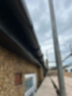 Close-up of a roofer installing new fascia boards on a home, ensuring proper fit and alignment for long-term durability