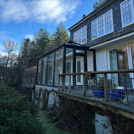 House with glass conservatory and deck