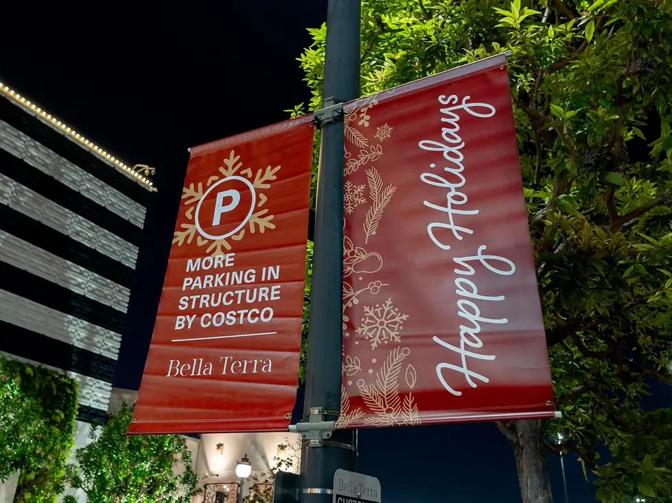 Red holiday banners with parking information at Bella Terra.