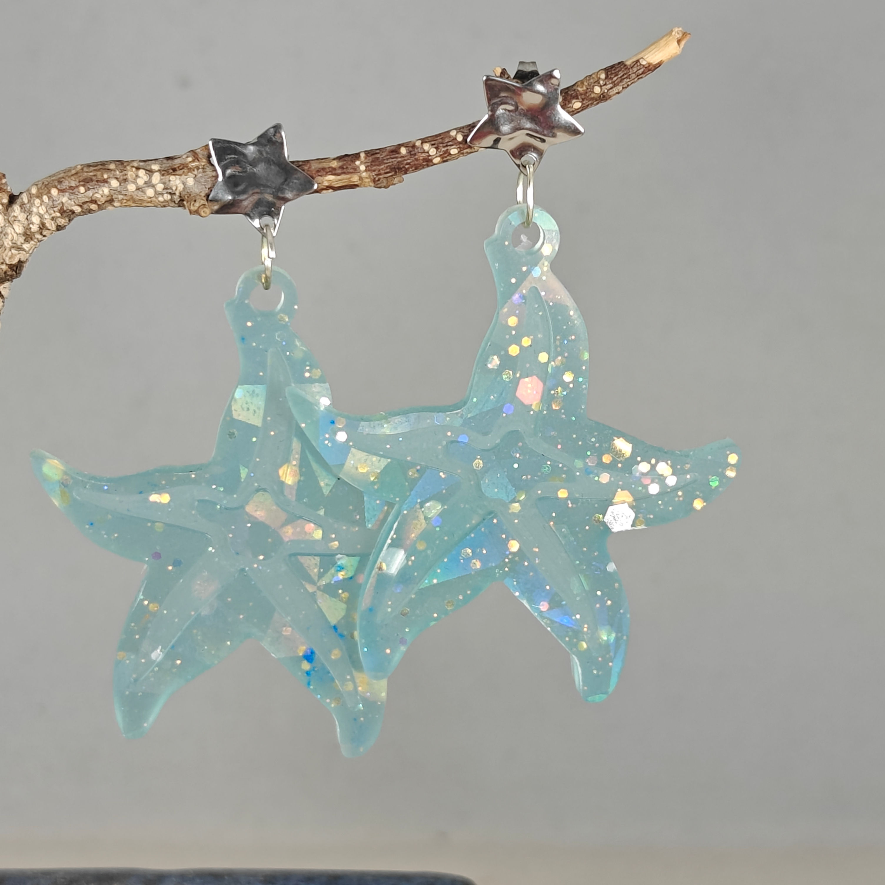 Boucles d'oreilles grande étoile de mer bleu phosphorescent 