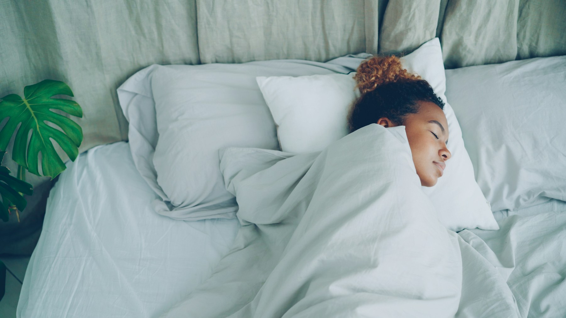 Person sleeping peacefully in a comfortable bedroom at night