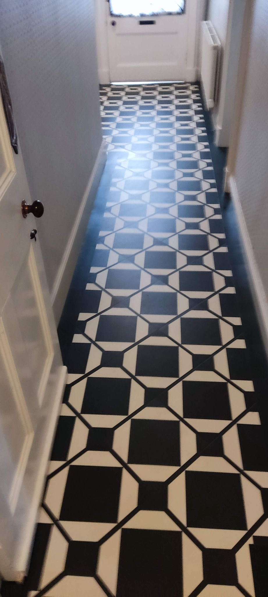 Black and white geometric hallway floor fitted in Bridge of Allan