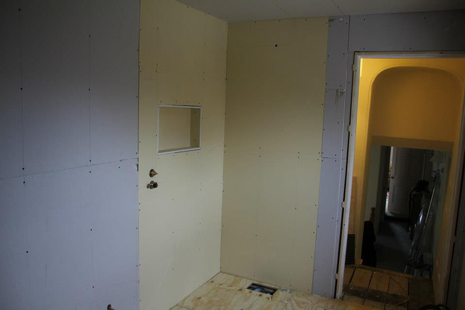 Walls boarded, integrated shelving included.