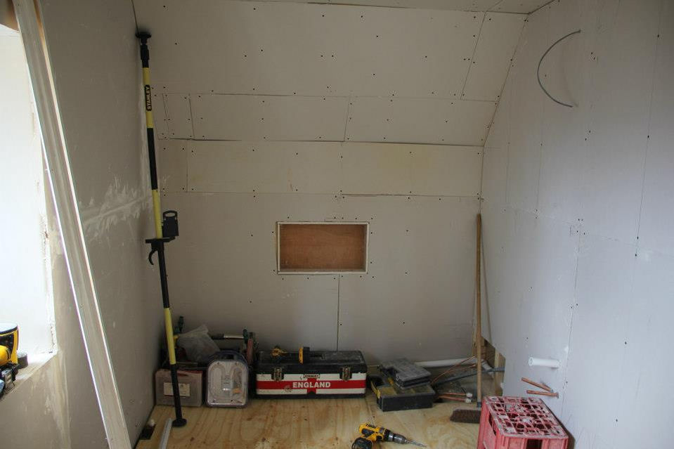 Tim Deane of JT Plumbing during a bathroom rip out. 