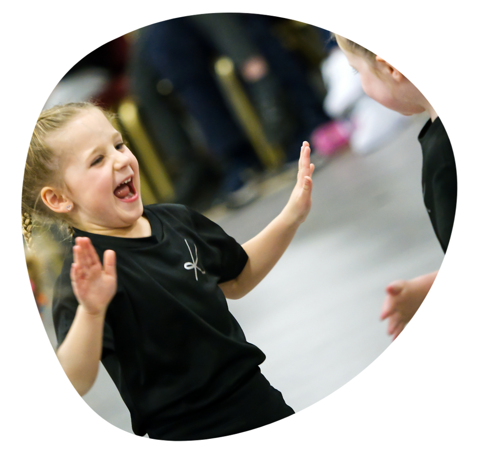 2 preschool dancers having fun with each other