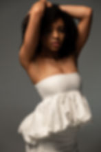 off-white linen strapless peplum top with a softly gathered, voluminous hem, structured bodice and airy, cloud-like shape