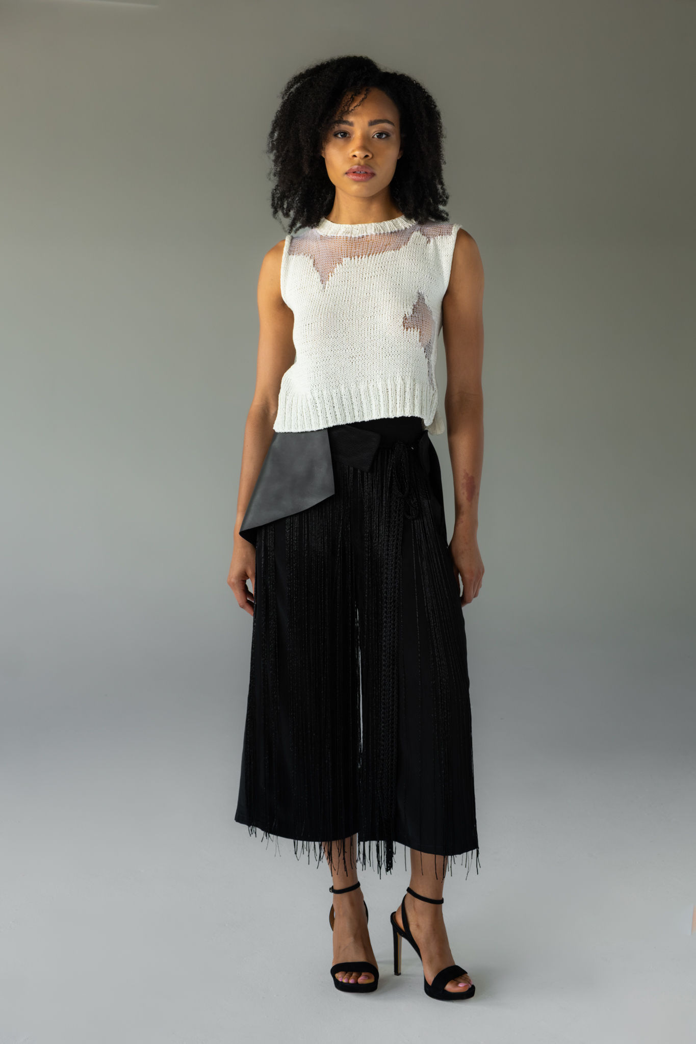 black structured leather belt, bold, flared silhouette at the waist, front view