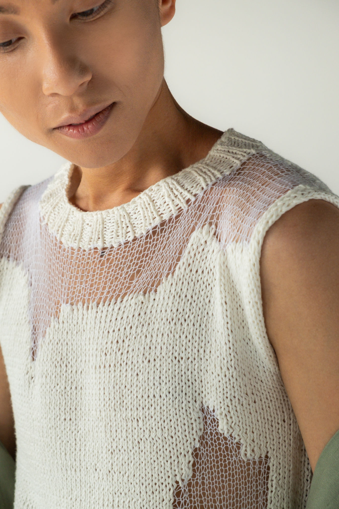 White knit tank with scattered sheer areas, showcasing hand-done distressing and natural drape, front detail view, male