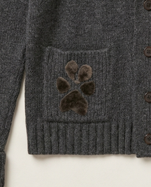 Close-up detail of a small, highly textured, felted pet fiber paw print memory motif seamlessly integrated into the pocket