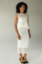 Hand-crocheted sleeveless overlay top in white cotton with an open weave pattern, front view
