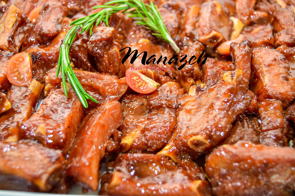 Tender glazed ribs garnished with rosemary and cherry tomatoes, one of Manazeh Catering’s signature event dishes.
