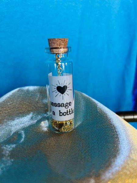 Thumbnail: "message in a bottle" "Never Give Up" Gold