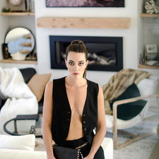 Editorial Model shot in a modern house standing in the living room by the staircase shot by editorial photographer in calgary