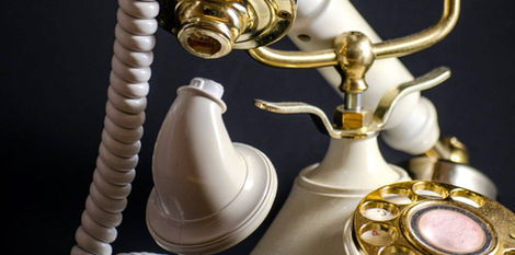 Vintage rotary telephone with ear or mouth piece falling off shot by product photographer in Callgary