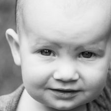 close up shot of a toddler in black and white shot by Calgary family and children photographer