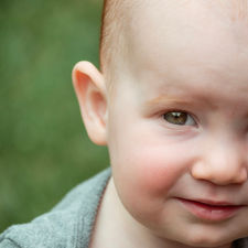 close up shot of a toddler with red hair and green eyes shot by Calgary family and children photographer