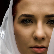 Close up portrait of female model with a head scarf and brilliant red hair shot by editorial portrait photographer in Calgary