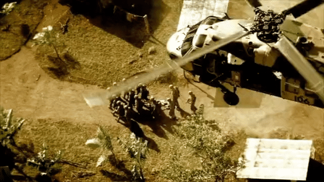 Australian officer evacuates stretcher through a chaotic war zone, guiding his team amid a storm